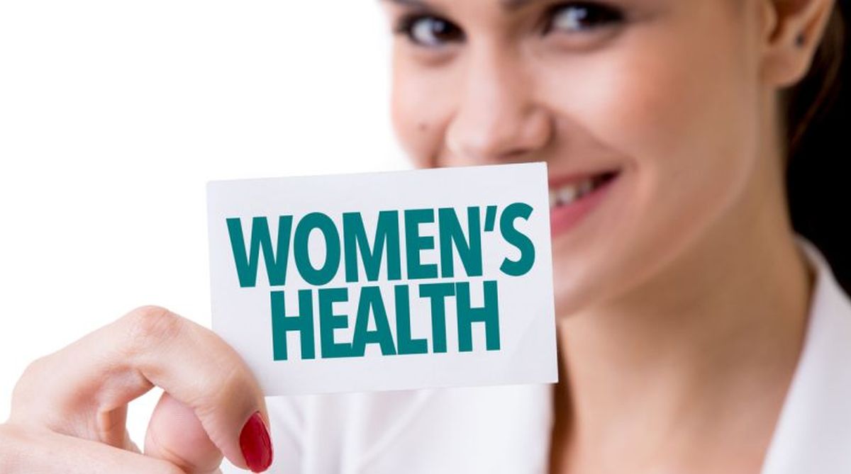 A woman holding card in hand ""women HEALTH"